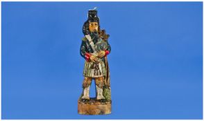 `Garnier Liquers` Decanter in the form of a Scots man in kilt with bagpipes. 13 inches in height.