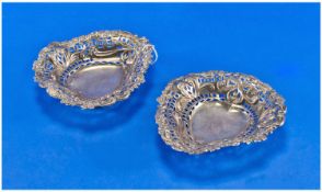 Pair of Late Victorian Silver Bon-Bon Dishes, each elaborately chased and pierced in the Rococo