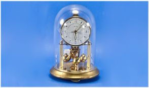 Small 300 Day Brass Clock Under Glass Dome By Bentina. 7 inches high.