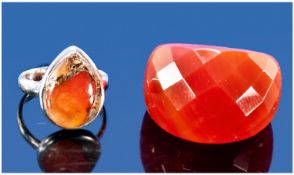 Two Rings. 1) An unusual ring carved from one piece of Carnelian of around 60cts, probably Chinese.