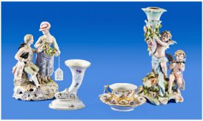 Four Pieces Of German Porcelain. 1, Plaue comport or candelabrum base, two putti frolicking, one