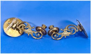 Pair of Brass Wall Candlesticks with ornate scrolling  arms and sconces with round wall back