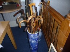 Blue And White Stand Containing 15 Various Walking Sticks.