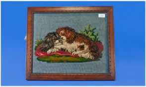 Victorian Tufted Carpet Picture, depicting two dogs lying on a settee. With glass eyes. In oak