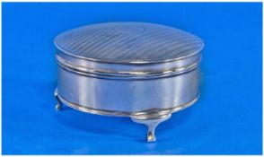 A Silver Lidded Round Trinket Box, raised on 3 curved legs, Hallmark Chester 1919. Bright cut