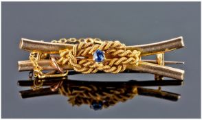 Victorian 18ct Gold Knot Brooch Set With Single Sapphire, complete with safety chain. Stamped 15ct,