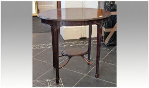 Edwardian Mahogany Occasional Table, of oval two-tier form, raised on tapering legs, measuring 28