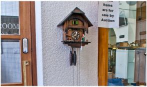 Small Black Forrest Cuckoo Clock, with three weights and pendulum, the weights in the form of