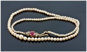 Fine Strand Cultured Pearl Necklace With Diamond And Ruby Colured Stone Set Clasp. Length 17
