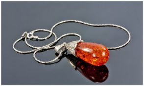 Amber Coloured Pendant With Silver Mount And Chain.