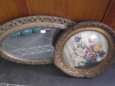 Oval Gilt Framed Mirror with a round gilt framed oil of flowers. Signed Jensen.