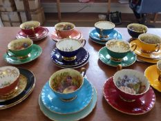 Collection of Assorted Aynsley Cups, Saucers and Side Plates. Various colours with still life