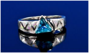 Silver Dress Ring Set With A Central Blue Stone And Inlaid With Opal Coloured Shoulders.