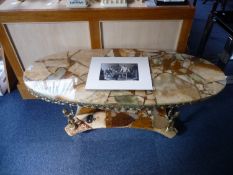 Modern Onyx Topped Coffee Table, the top being supported by four Classical gilt figures, raised on