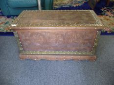 Carved Wooden Zanzibar Chest with brass straps and studs. On a bracket feet base. 16 by 33 by 15