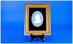 An Oval Wedgwood Plaque Of Sir Winston Churchill, modelled by Arnold Maching in gilt frame. 8`` x