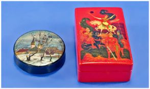 Two Russian Paper Mache Boxes Comprising A Circular Black Lacquered Box, The Detachable Lid Showing