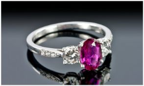 18 Carat White Gold Ladies Ruby and Diamond 3 Stone Ring, the central faceted oval ruby of good