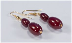 Dark Cherry Amber Drop Earrings, each earring comprising two graduated oval ambers suspended from