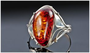Large Silver and Amber Bangle, stamped 925, the bangle with sinuous curves, supporting a