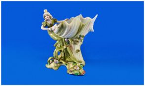 Art Nouveau Saxony Figural Posy or Sweetmeat Dish, the shell shaped bowl raised on a matching,