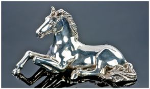 A Realistic Model Of A Horse Sat In Repose. Signed to the reverse and stamped 925 and other marks.