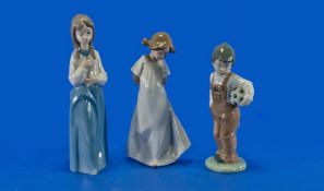 Three Nao by Lladro Figures comprising boy with football, girl with nightdress and girl with hands