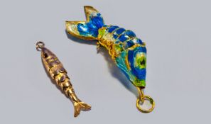 Two Articulated Fish Pendants. 1). A 9ct gold fish. 1.5 inches long. 2). A silver gilt and blue