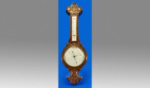 Carved Oak Late Victorian Barometer with enamel dial and thermometer. c 1900 A/F. 33 inches in