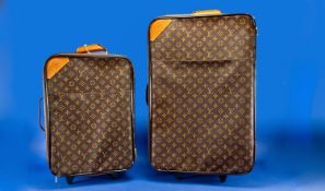 Set of Two Matching Wheeled Suitcases, each with classic Louis Vuitton monogram fabric with dark