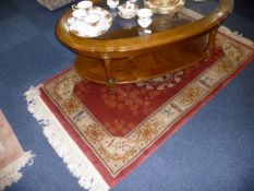 Chinese Woolen Rug, decorated with symmetrical floral patterns on a red ground, measuring 36 by 68