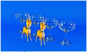 Set of Four Babycham Glasses, with two Babycham doll figures.