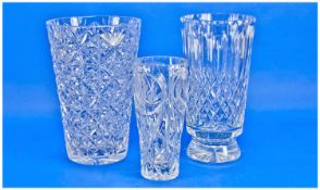 Three Various Cut Glass Vases, all with elaborate cut bodies and star cut bases, highest measuring