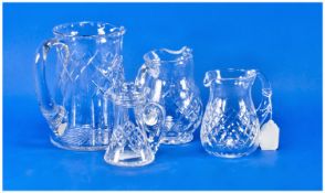 Collection of Four Cut Glass Jugs, comprising one large, two smaller jugs and one lidded jug.