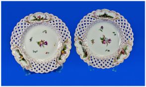 A Pair Of 19th Century Painted Meissen Plates, with reticulated borders, painted with vignettes or