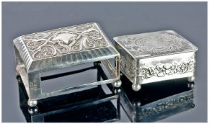 A 1920`s Silver Embossed And Chased Matchbox Holder, raised on four ball feet. Hallmarked for