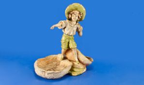 Austrian Amphora Figural Dish, circa 1900, depicting a young boy holding a ball in left hand,