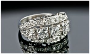 A Fine Platinum Set 3 Stone Diamond Ring. The central brilliant cut 3 diamonds flanked by small