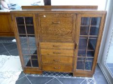 Early 20th Century Oak Side Cabinet, made by `T.B & W Cockayne`, fitted with two glazed doors, with