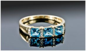 9ct Gold Dress Ring, Set With Three Princess Cut Blue Topaz Stones Between Diamond Set Spacers,