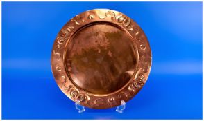 An Arts and Crafts Copper Round Tray Embossed with a Floral Pattern in the style of liberty`s. 14