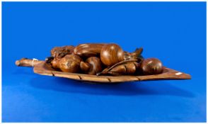 Rosewood Naturistic Fruit Bowl, with carved wooden fruit, the bowl measuring 25 inches long.