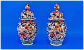 A Pair of Ovoid Shaped Imari Vases, 11 inches high, one A/F. c 1860
