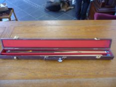 Snooker Cue in a brown case.