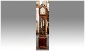 Small Sized Brass Faced Grandmother Clock. 64`` in height. With two weights and arched brass dial.