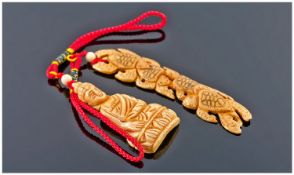 Two Modern Carved Bone Pendants.