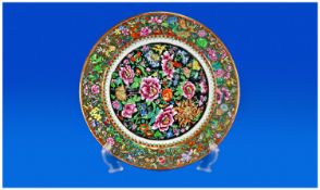 Famille Rose Style Cabinet Plate, hand painted over print outlines, the centre with a profusion of