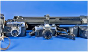 Collection Of Camera Equipment. Full size tripod, flash, Halina camera and Olympus camera.