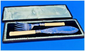 A Pair of Fish Knives and Forks in fitted case with engraved blades with ivory handles.