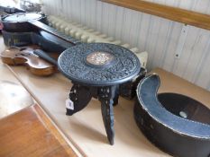 Small Ebonised Oriental Wooden Stand, the top ornately carved with foliage, the centre inlaid with